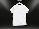 Model wearing a white oversized t-shirt featuring a popular internet culture design against a plain backdrop.
