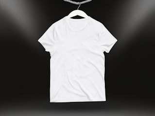 A close-up of a soft cotton t-shirt draped over a chair in natural light.