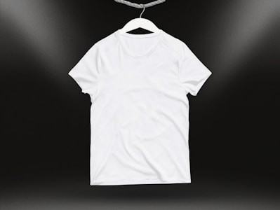 A close-up of a blank white t-shirt on a wooden table.