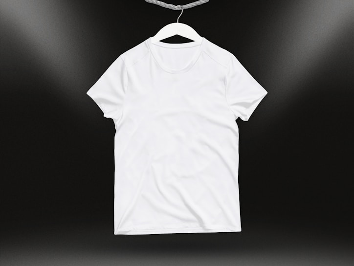 Front view of a casual cotton t-shirt displayed on a wooden hanger against a plain background.