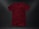 A plain, deep red t-shirt placed against a dark textured background. The garment appears to be crumpled slightly, showing natural folds and shadows. The fabric looks soft, and the shirt is displayed in a casual, relaxed style.