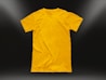 A plain yellow t-shirt is centered against a dark background, illuminated by subtle light gradients in the corners. The shirt is neatly laid out, highlighting its texture and smooth fabric.