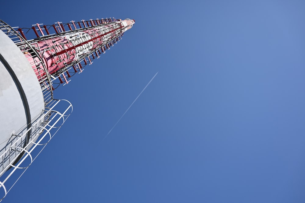 a red and white tower against a blue sky