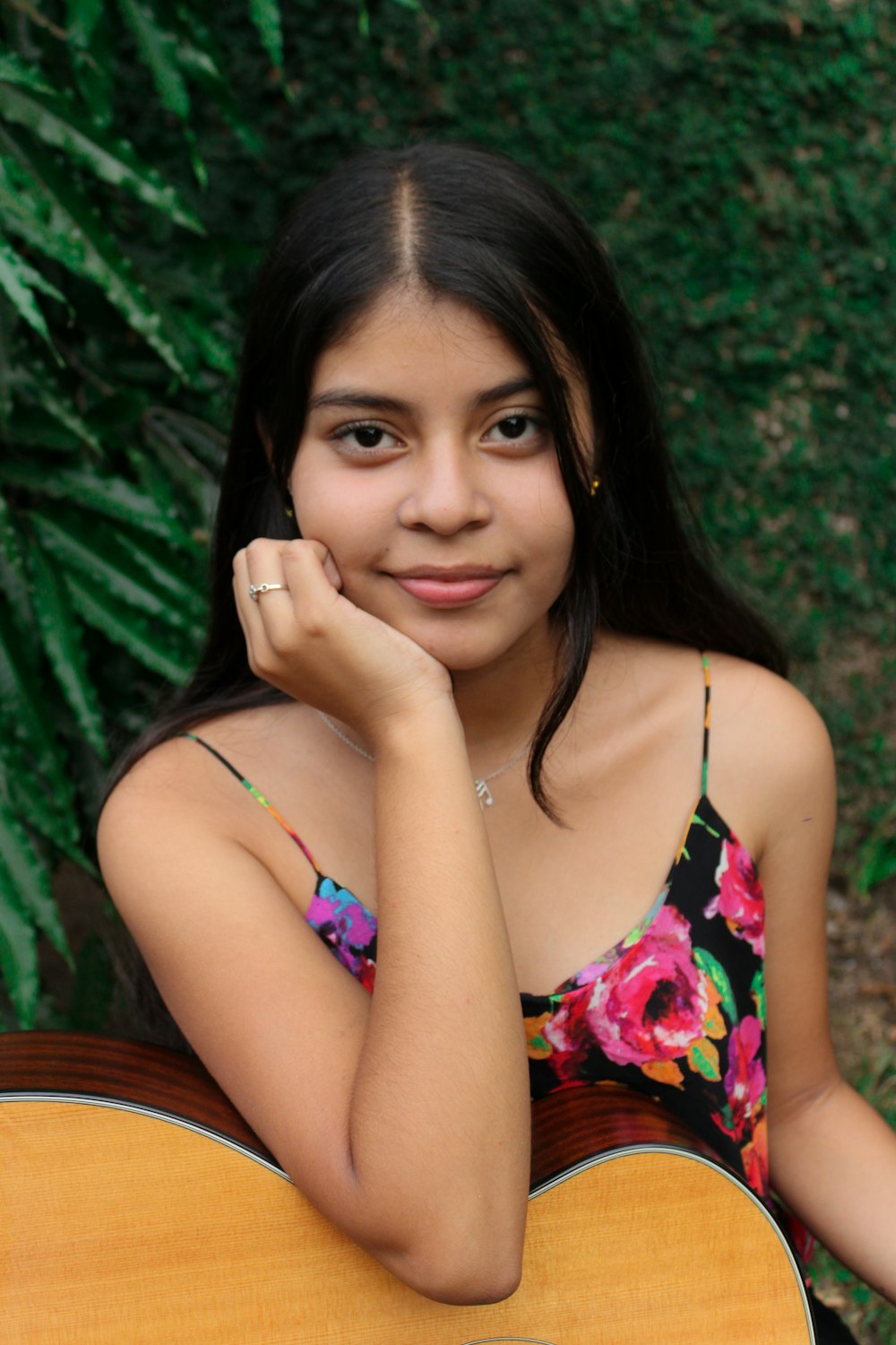 a girl with a guitar posing for a picture