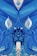 An abstract painting with flowing blue brushstrokes creating a mirrored pattern. The composition features symmetrical shapes resembling flowers or leaves with a central figure that could be interpreted as an abstract creature or mask. Light and dark shades of blue dominate the canvas, with interspersed white accents adding contrast.