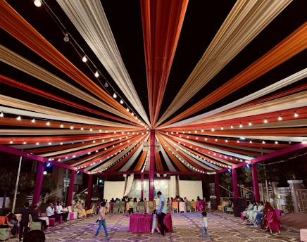 A vibrant event setup by Navya Enterprises in Bhopal, showcasing colorful decorations and happy guests.