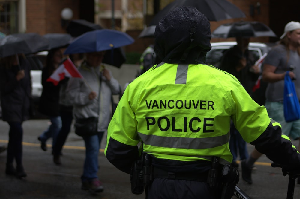 a vancouver police officer standing in the rain