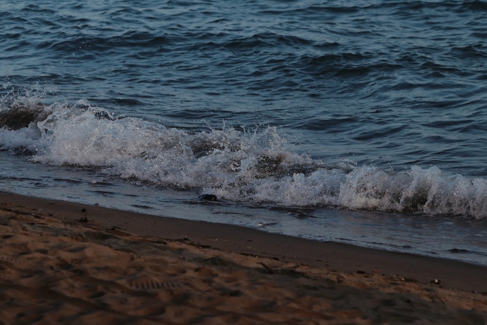 a beach with waves coming in to shore