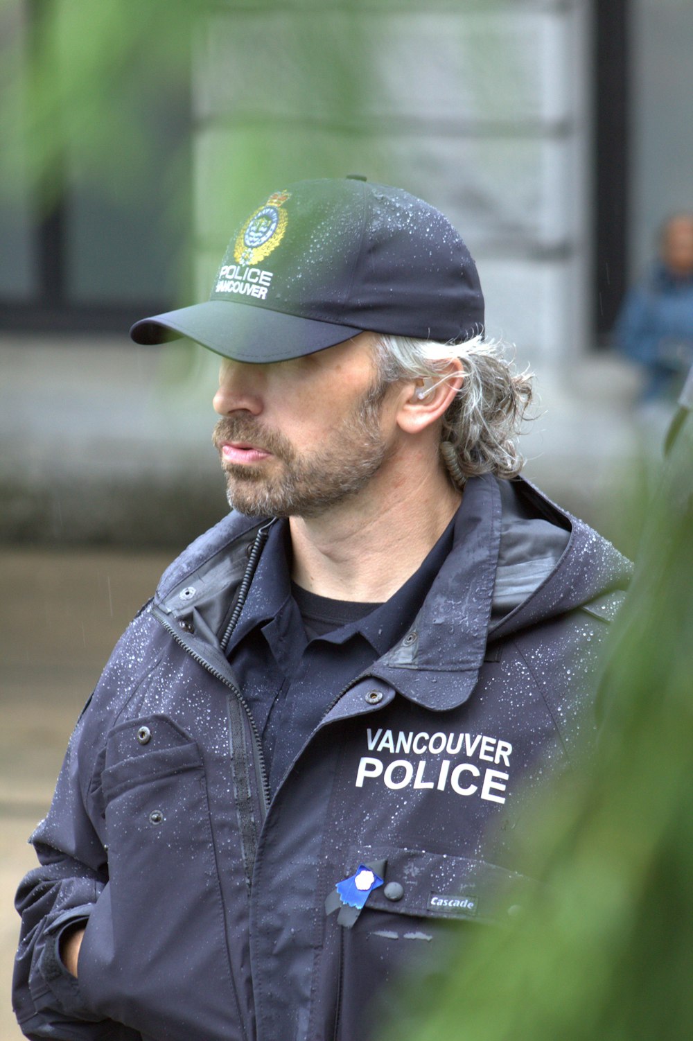 a man in a vancouver police uniform talking to someone