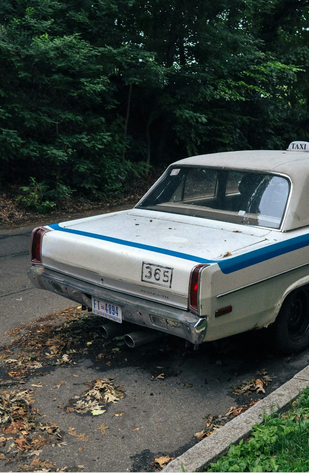 an old car parked on the side of the road