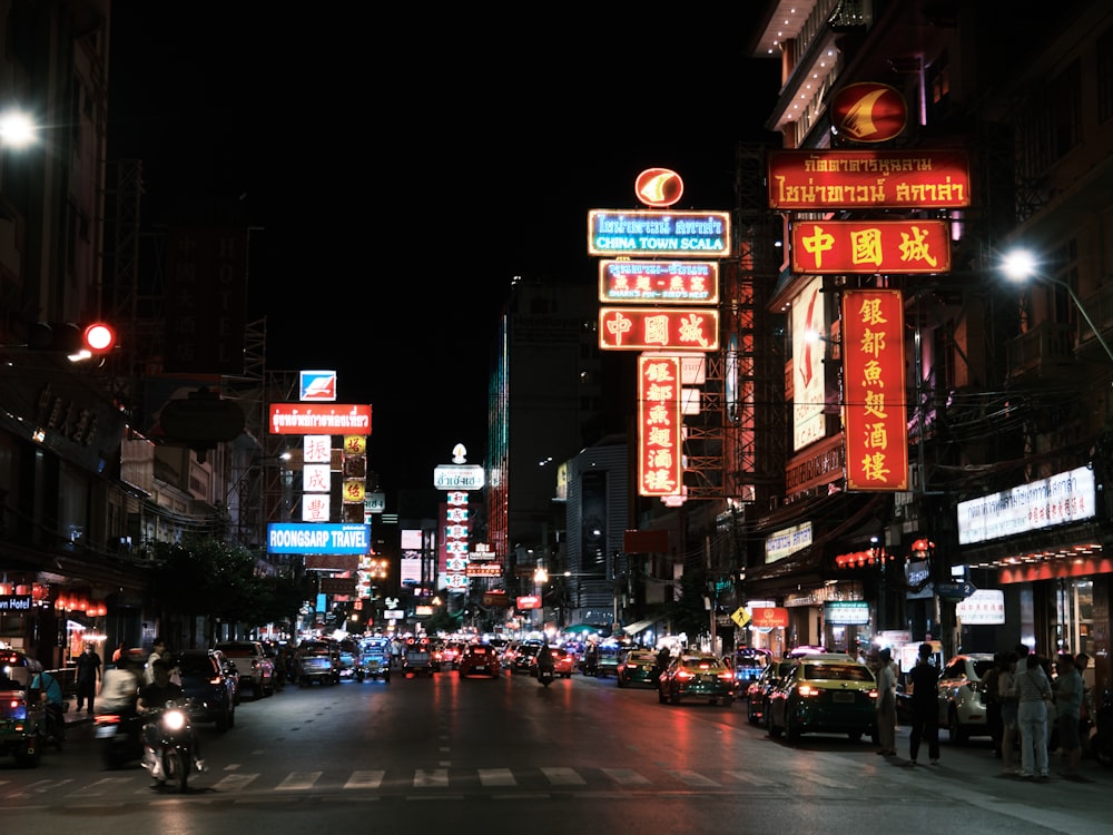 a city street filled with lots of traffic at night