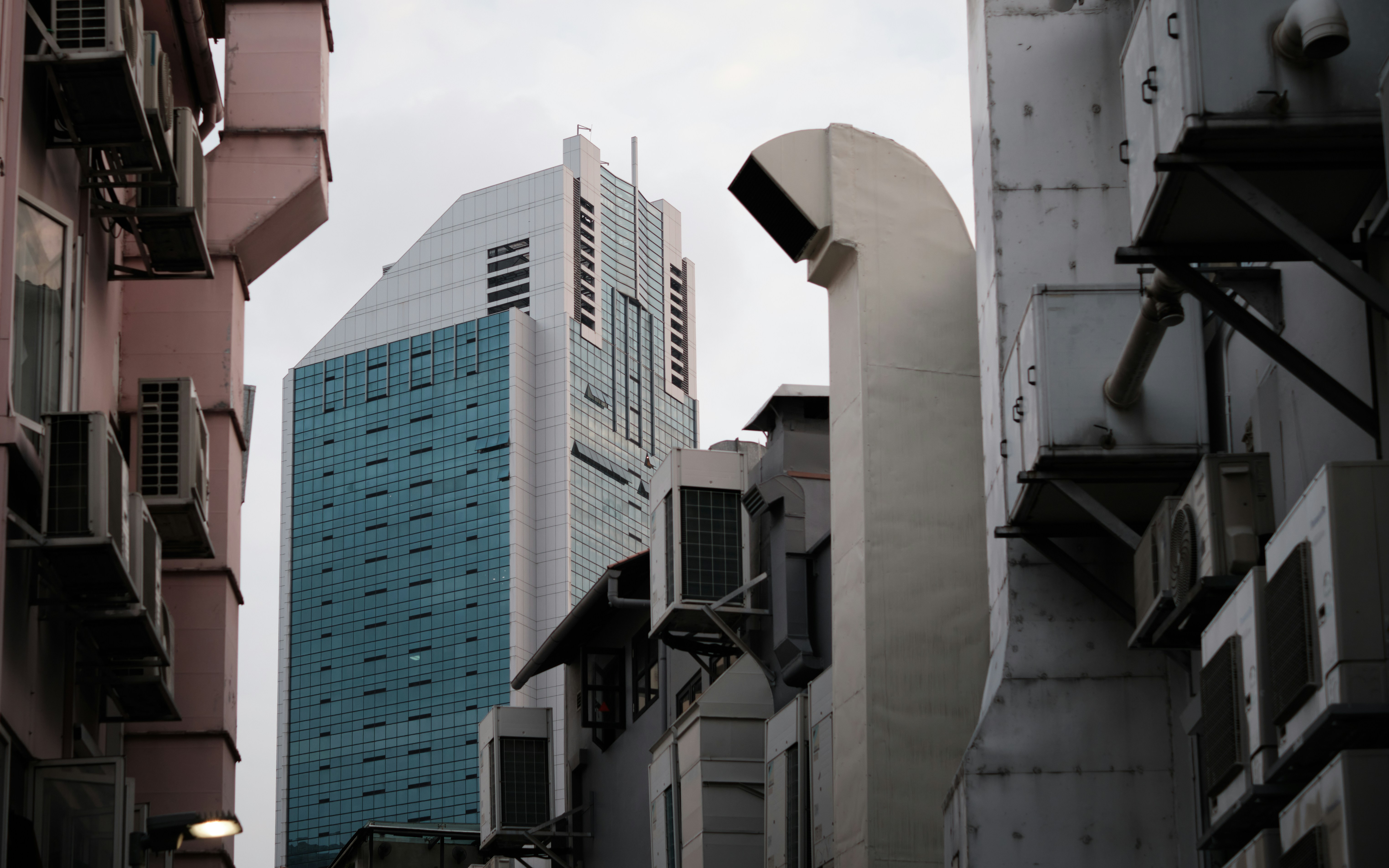 a city street with tall buildings in the background