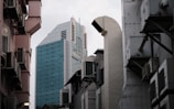 a city street with tall buildings in the background