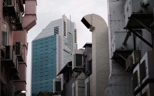 A modern commercial building in Dubai with sleek glass windows and visible HVAC ductwork.