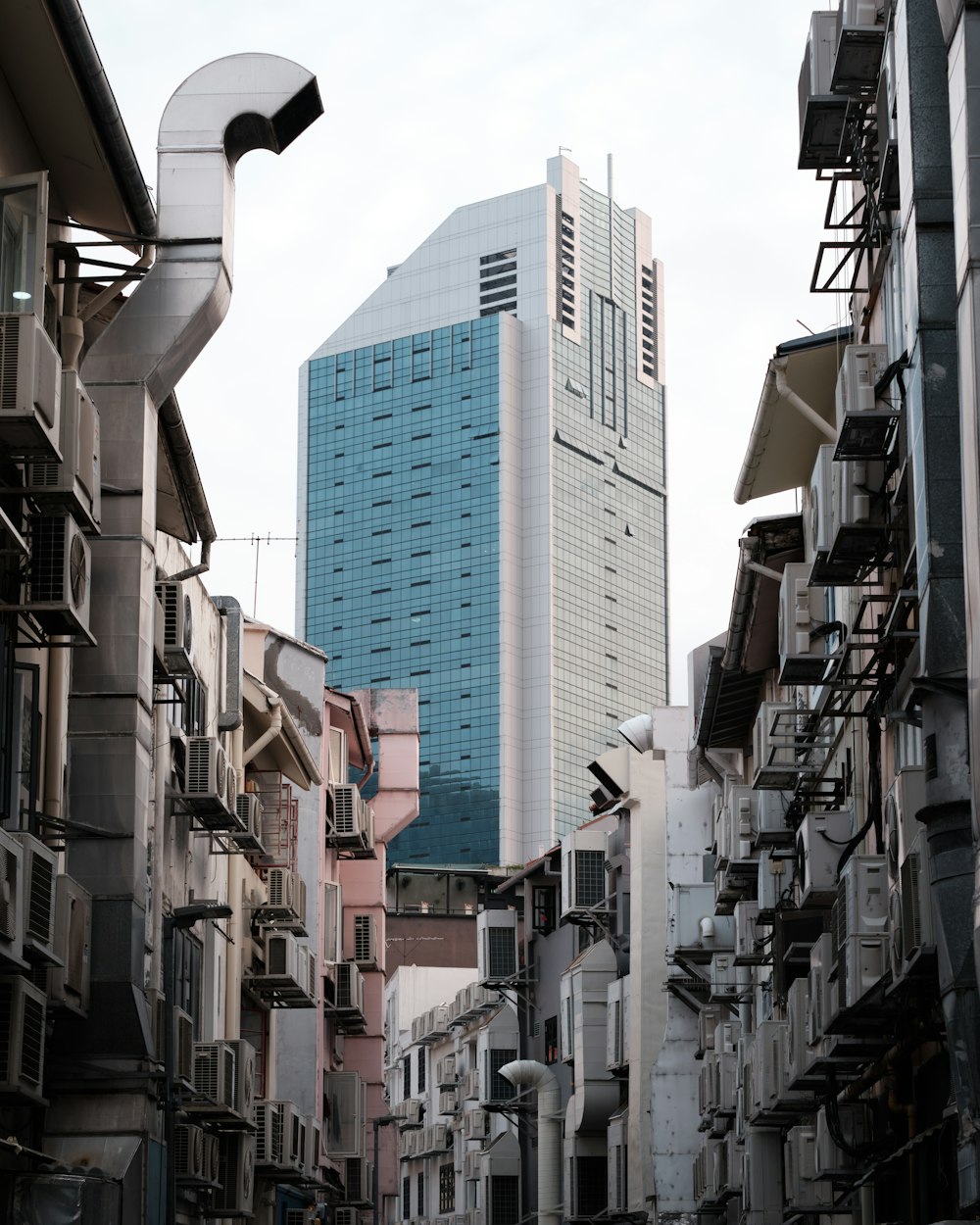 a very tall building towering over a group of buildings