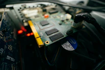 Close-up of a technician inspecting computer hardware components.