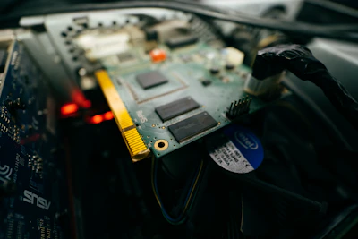 Close-up of a technician inspecting computer hardware components.