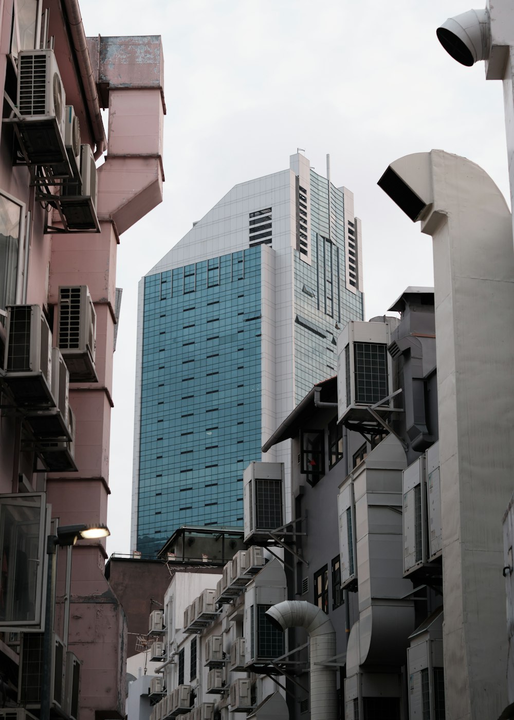 a city street with tall buildings and a traffic light