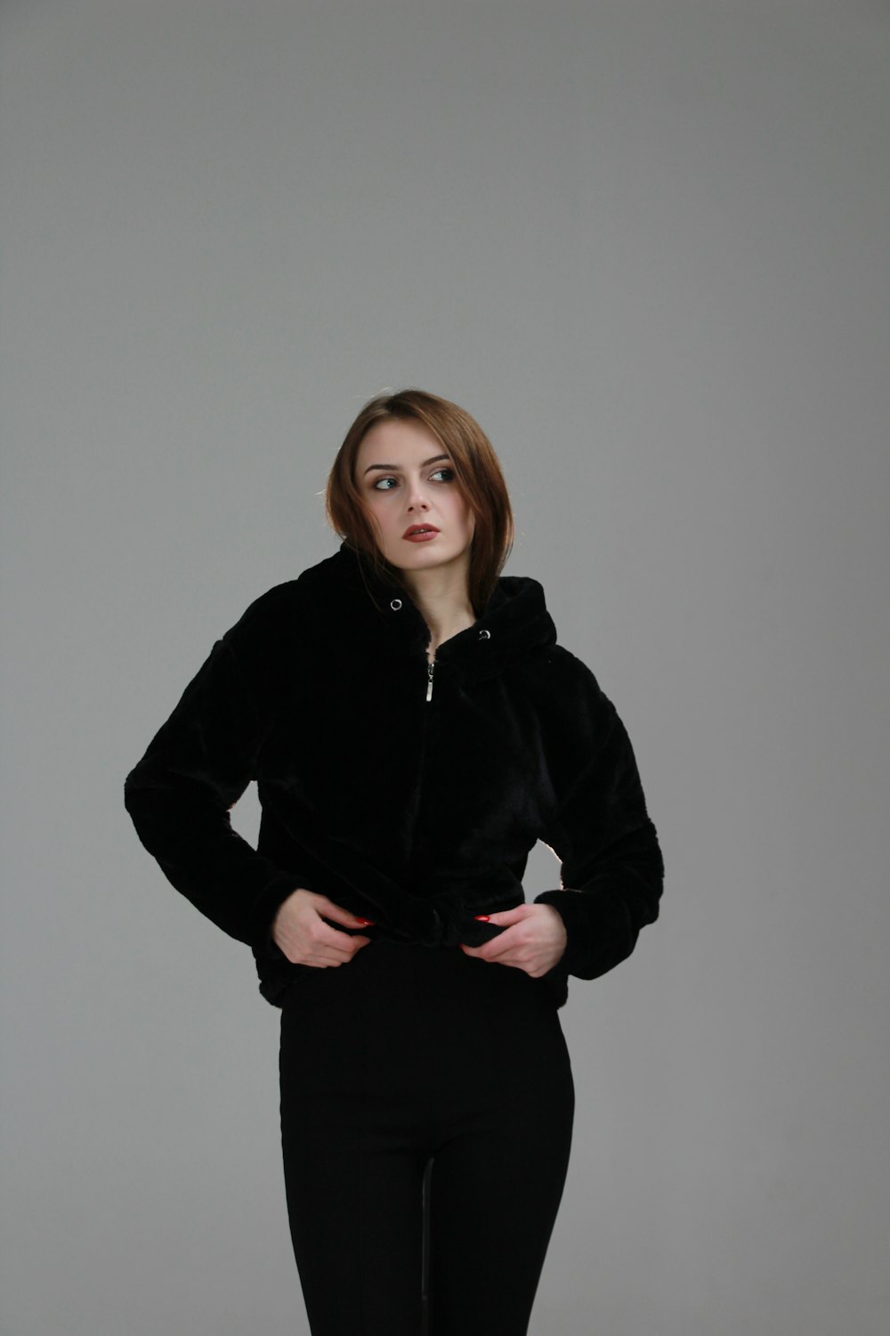 a woman in a black jacket posing for a picture