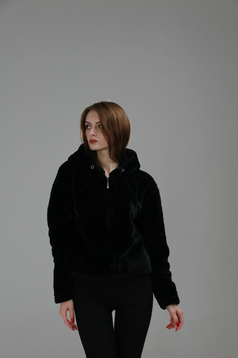 a woman in a black jacket and leggings
