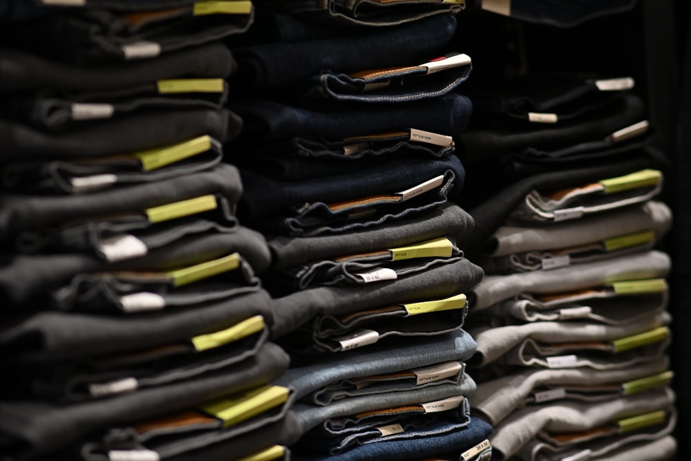 a rack of folded jeans in a store
