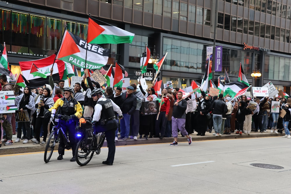 a group of people on a street with flags