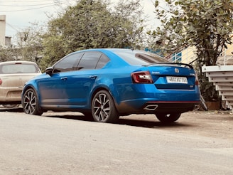 Front view of a reliable blue sedan parked on a sunny Colorado street.