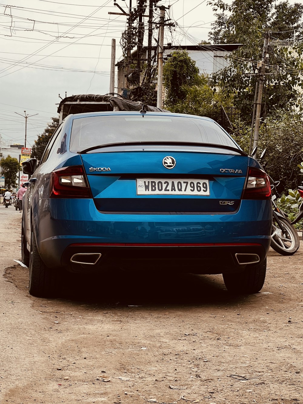 a blue car parked on the side of the road