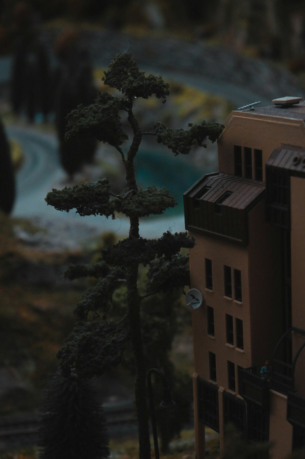 a model of a building with a tree in front of it