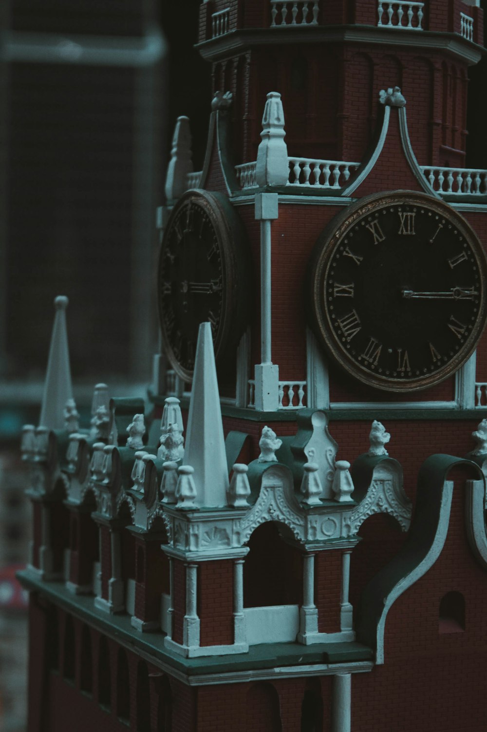 a red clock tower with a clock on each of it's sides