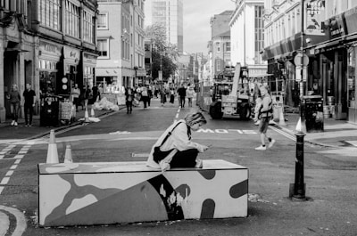A street scene where people are humorously texting while narrowly avoiding bumps.