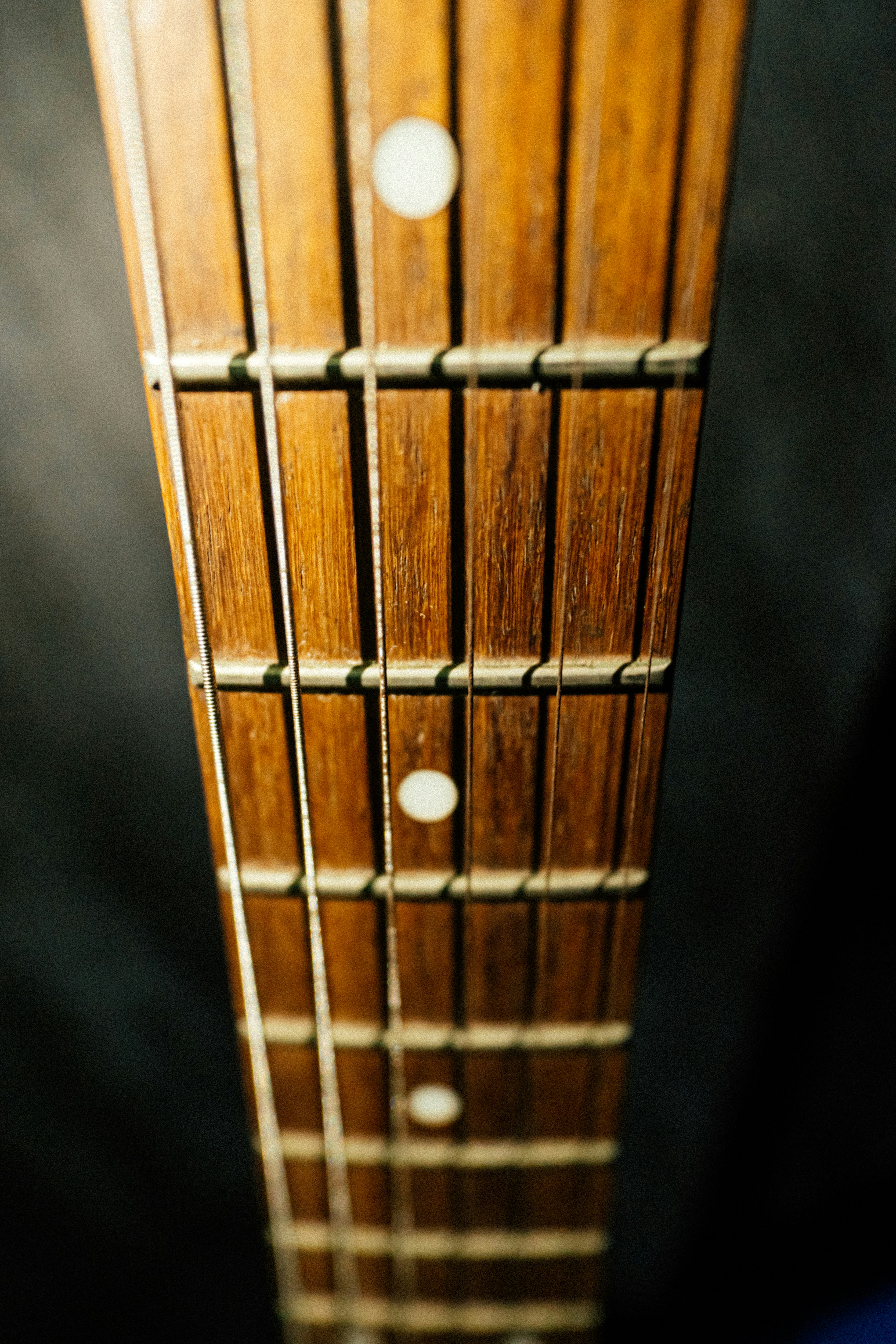 a close up of a wooden guitar neck