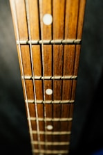 a close up of a wooden guitar neck