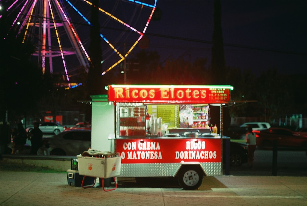 a food cart with a ferris wheel in the background