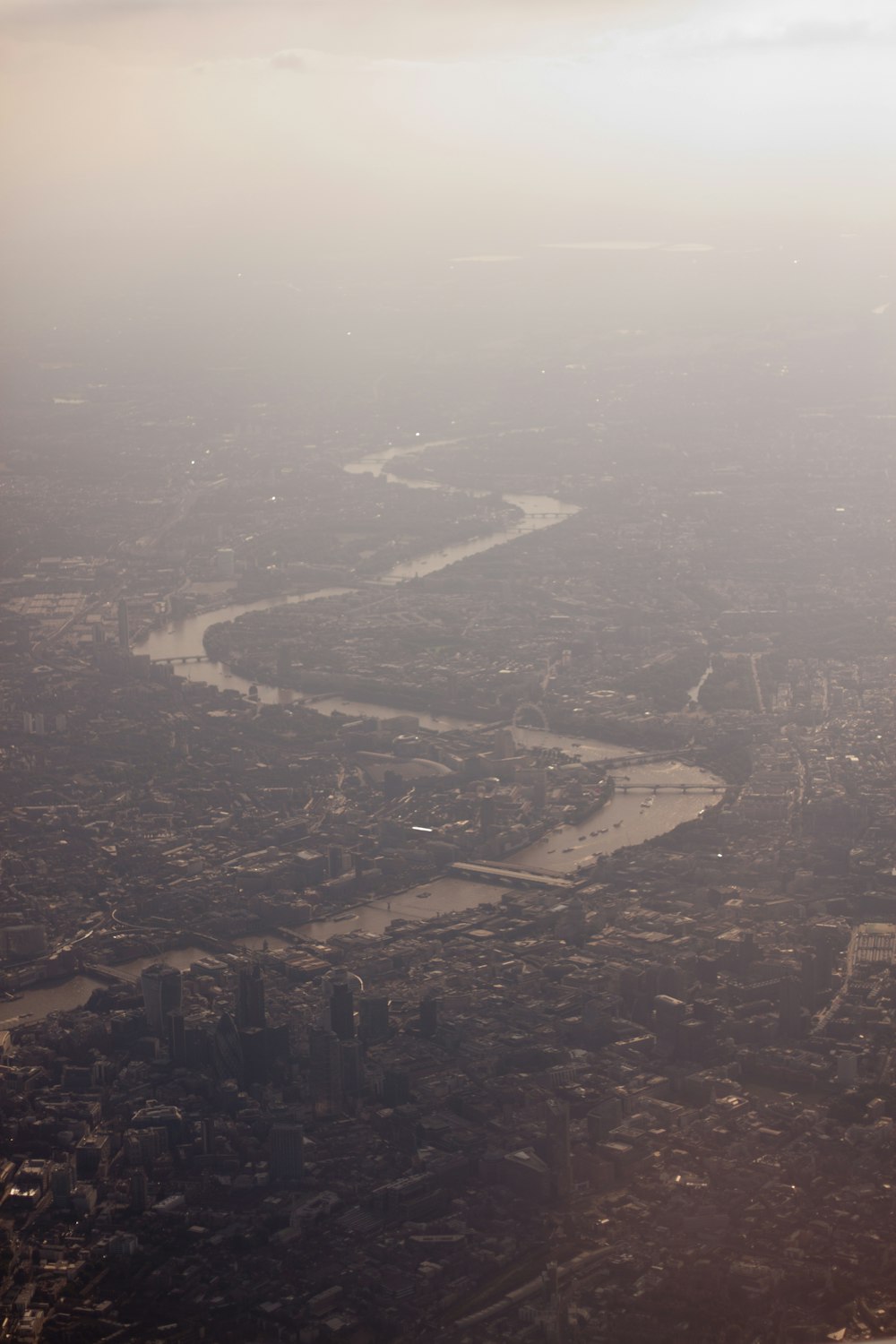 an aerial view of a river and a city