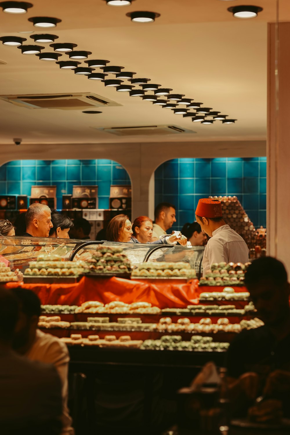 a group of people sitting at a table in a restaurant