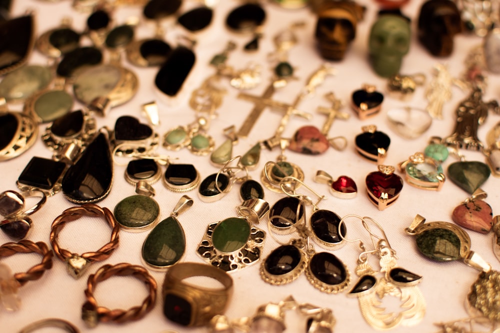 a table topped with lots of different types of jewelry