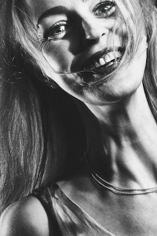 A detailed portrait capturing the gentle expression of a smiling subject.