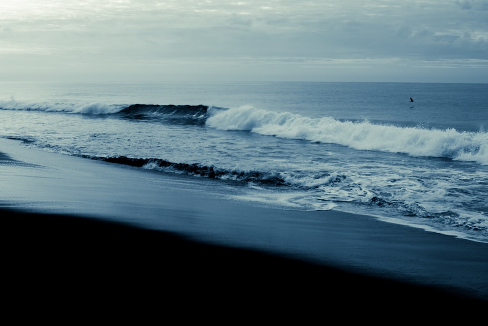 a person riding a surfboard on a wave in the ocean