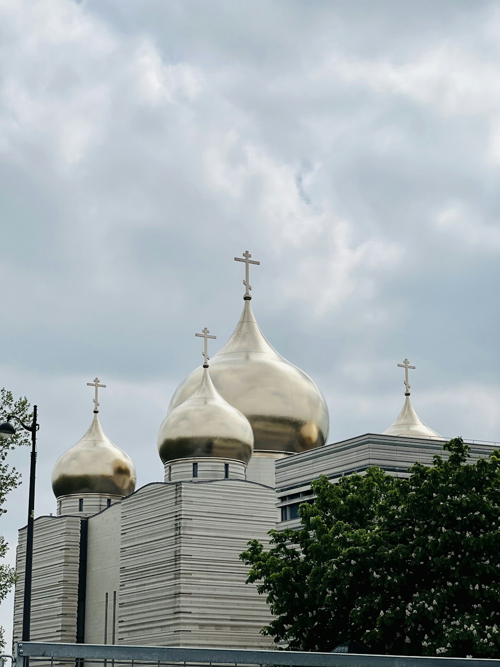 a church with three domes and a cross on top