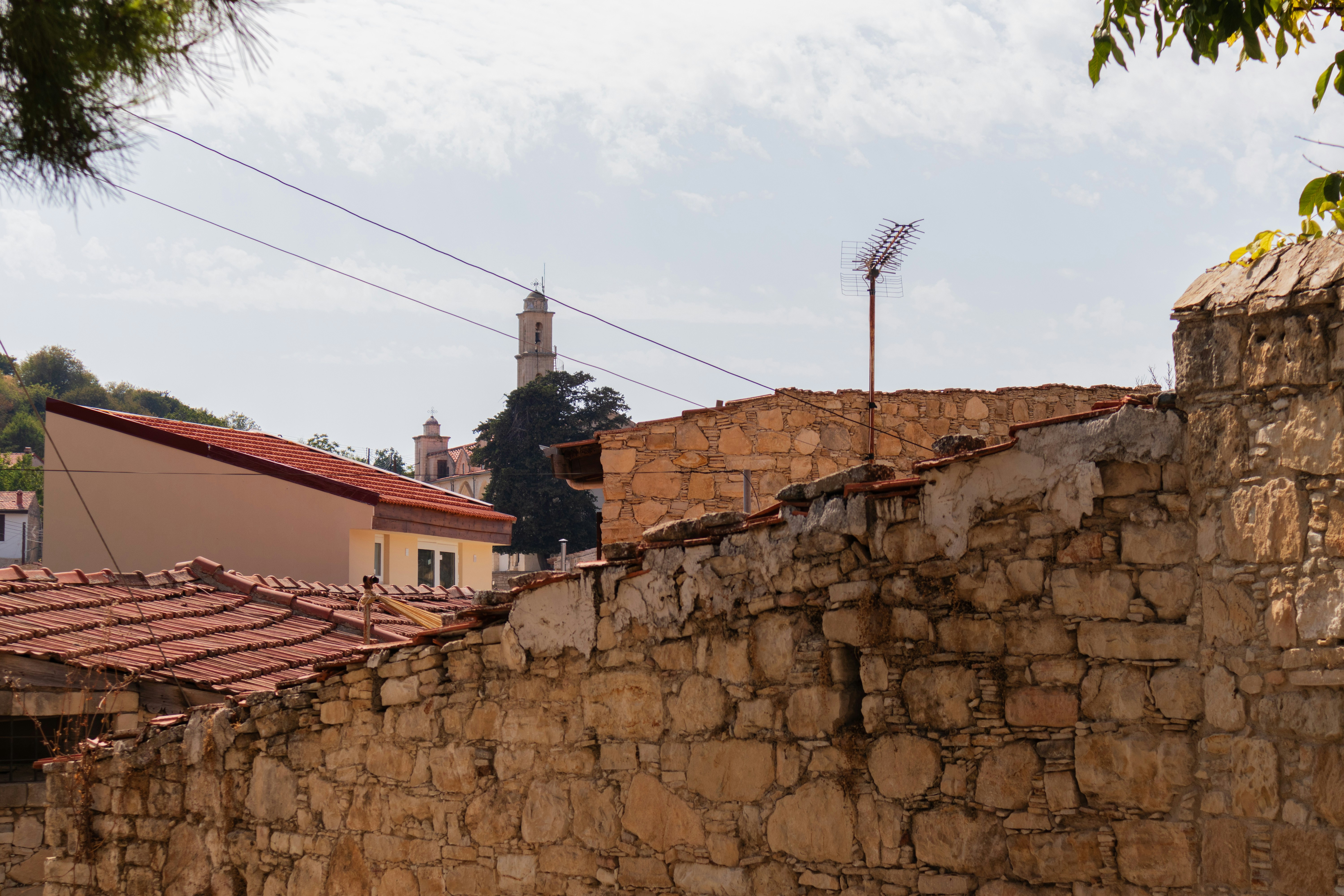a stone wall with a clock tower in the background