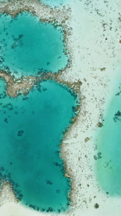 Aerial view of the three Gili Islands surrounded by clear turquoise water and coral reefs.
