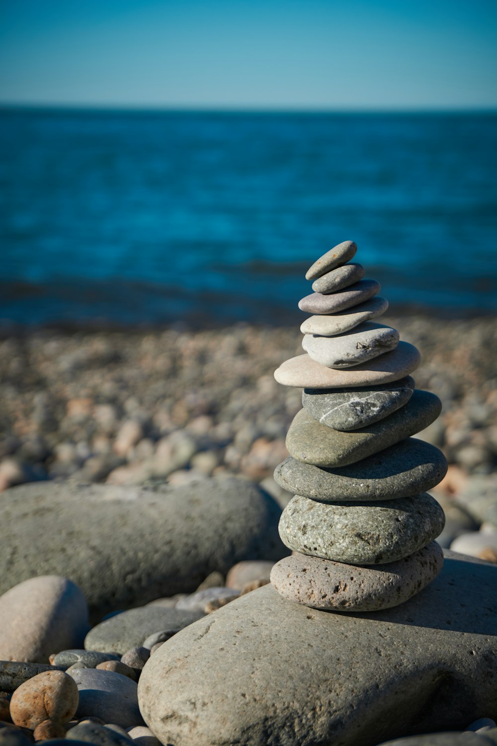 a pile of rocks sitting on top of a beach