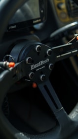 Close-up of a sim racing setup with branded peripherals in use.