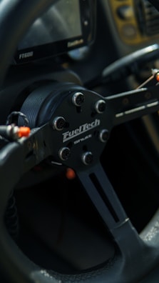 Detail shot of a kart's steering wheel and dashboard with custom branding.