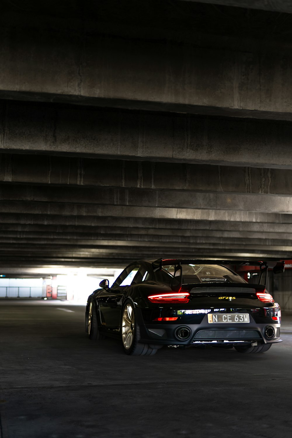 a black sports car parked in a parking garage