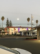 Evening shot of a well-lit community clubhouse with modern architecture.