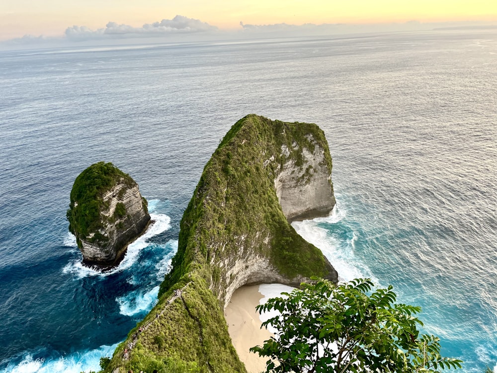 a couple of large rocks sticking out of the ocean