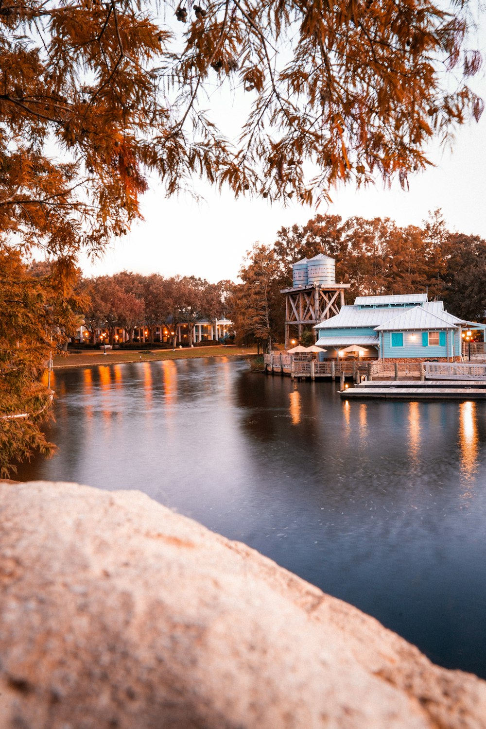 a lake with a boat dock and a house on it