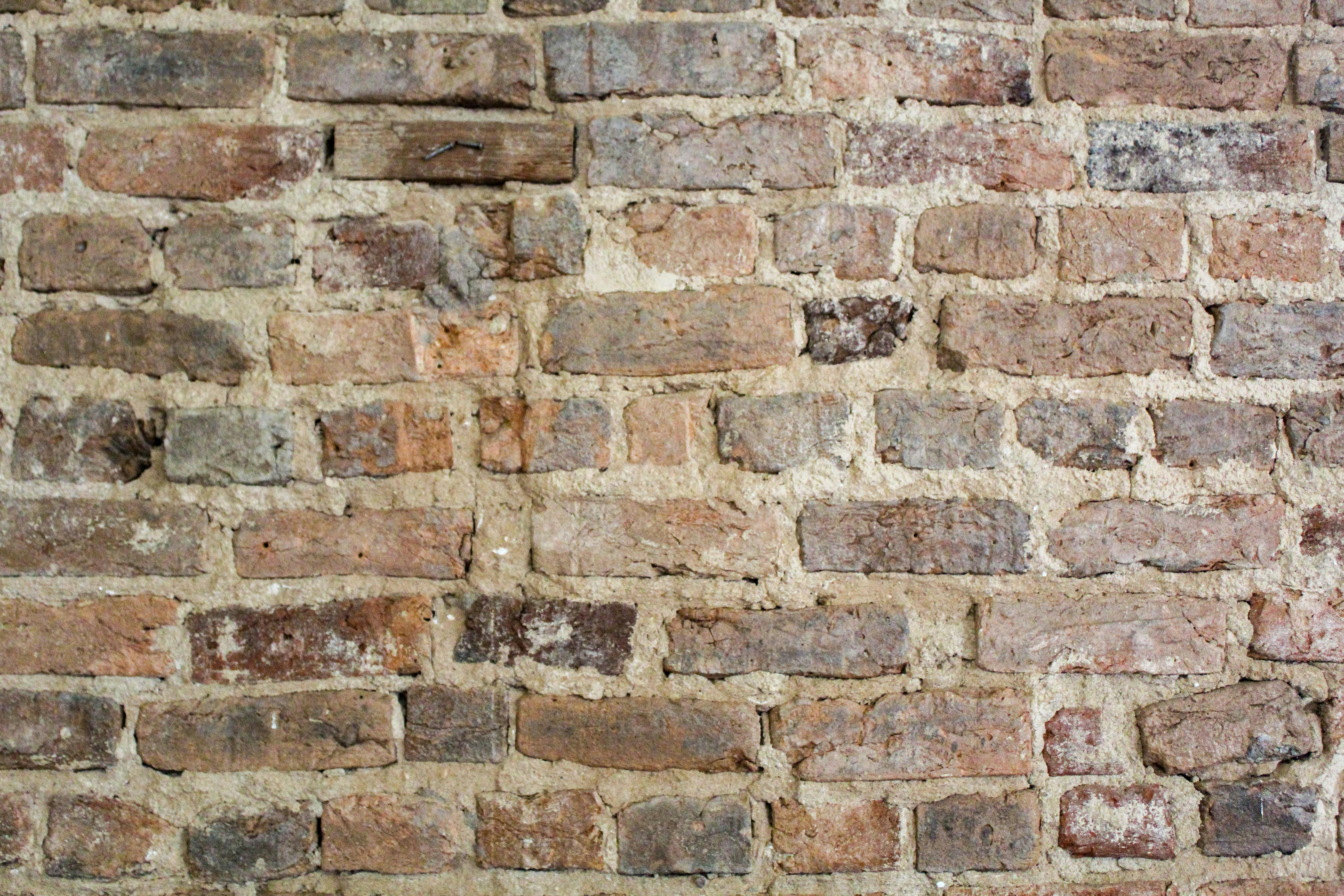 A close up of a brick wall made of bricks photo Free Brown Image on